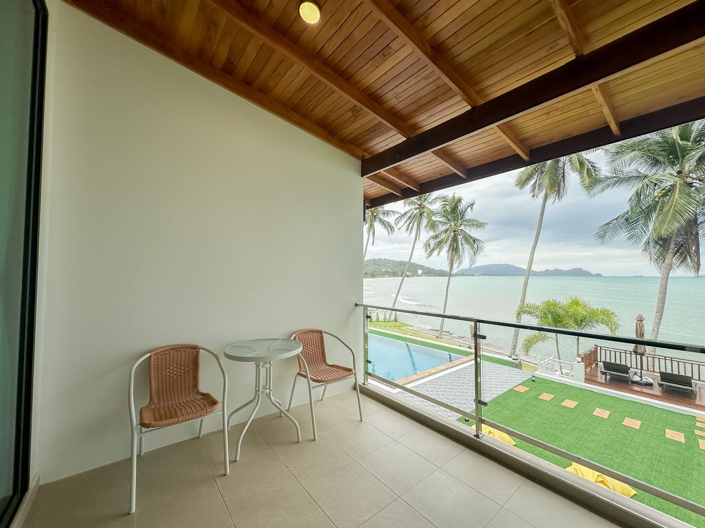 Lawn, pool and sea from a balcony